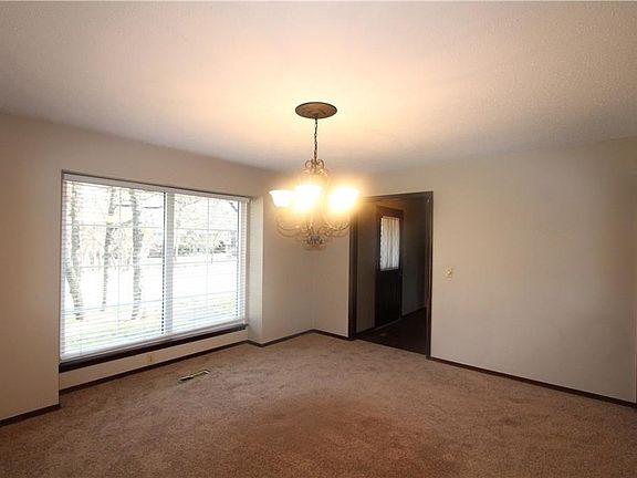 Separate dining room with 2"white faux wood blinds.