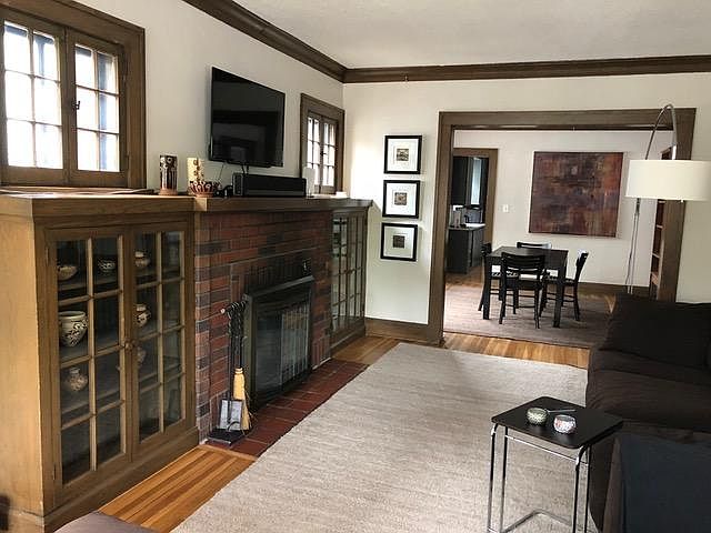 Separate dining room with original woodwork, built-in cabinets, and natural light

furniture in photos is from a previous tenant