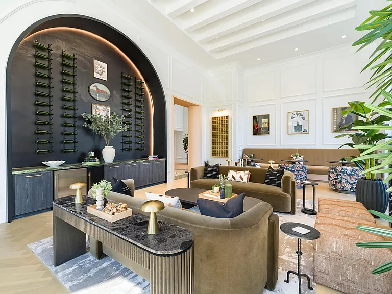 Resident lounge with arched wine display, tailored seating, and refined finishes reflecting Nashville's creative neighborhoods nearby.
