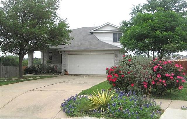 Adorable home on large cul-de-sac lot, beautifully landscaped front and back. Photo taken in April 2