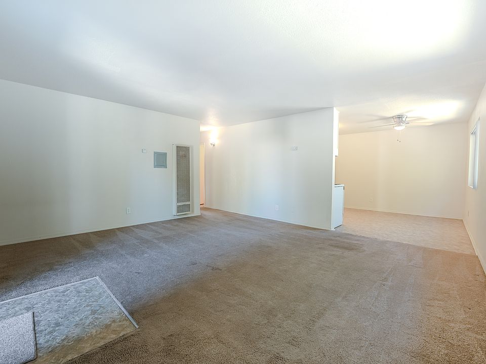Living room and dining area w ceiling fan, well lit