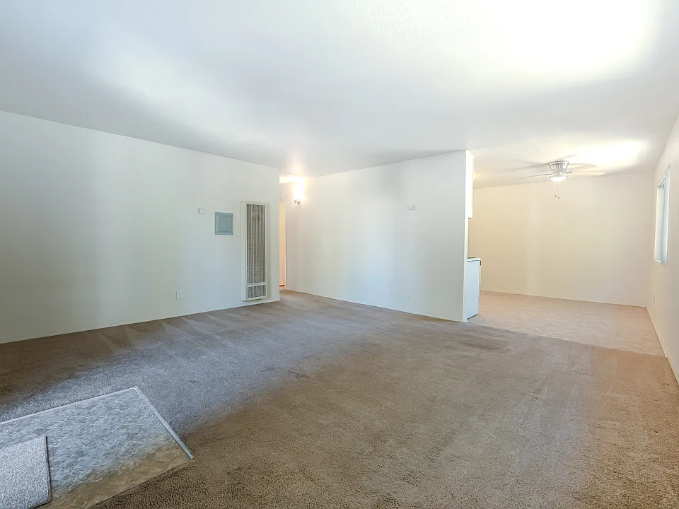 Living room and dining area w ceiling fan, well lit