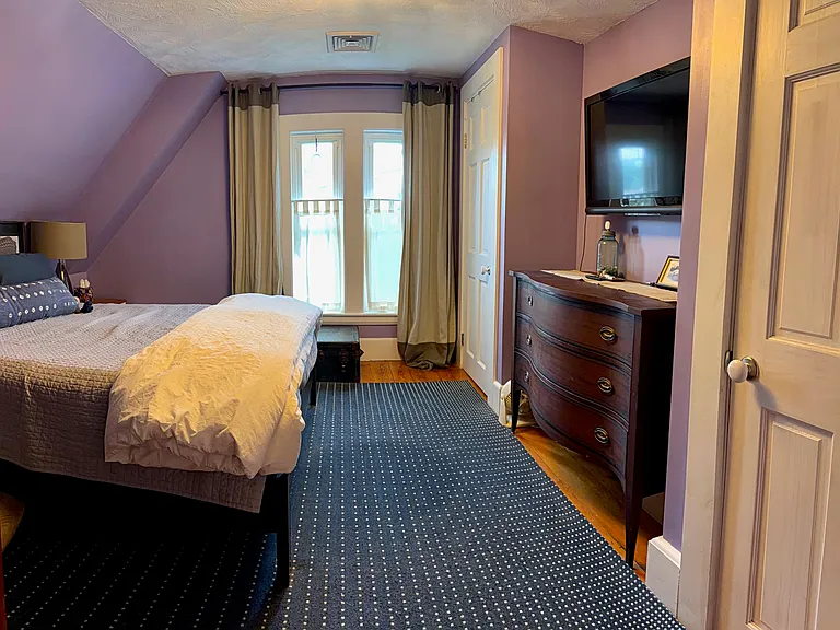 Third floor primary bedroom with two closets.