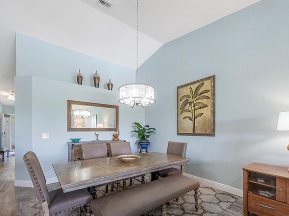 Dining room seats six and has storage credenza.