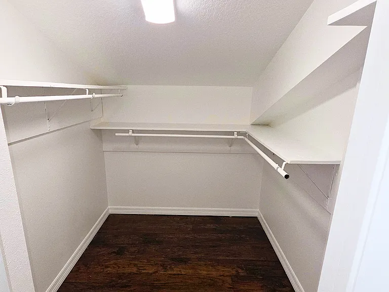 Spacious closet with ample storage for clothes and personal belongings.