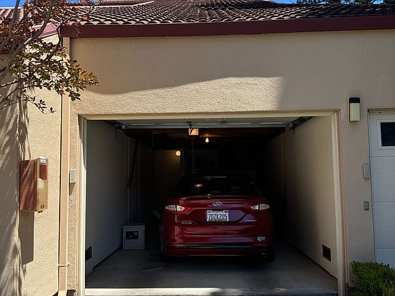 One car garage, with car charger, and ~ 200 sq ft. of attic storage space.