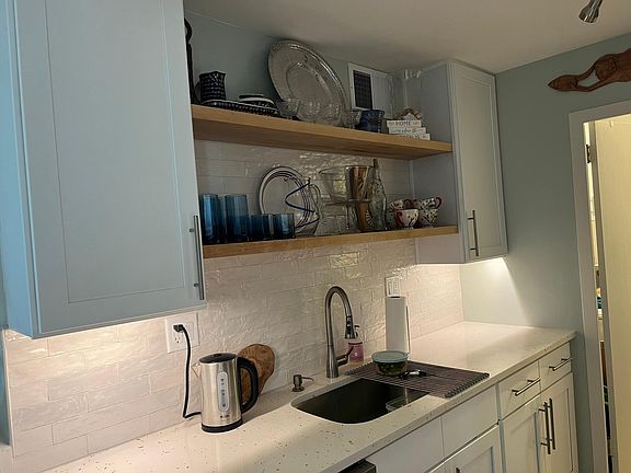 Kitchen with dishwasher, garbage disposal and open shelving