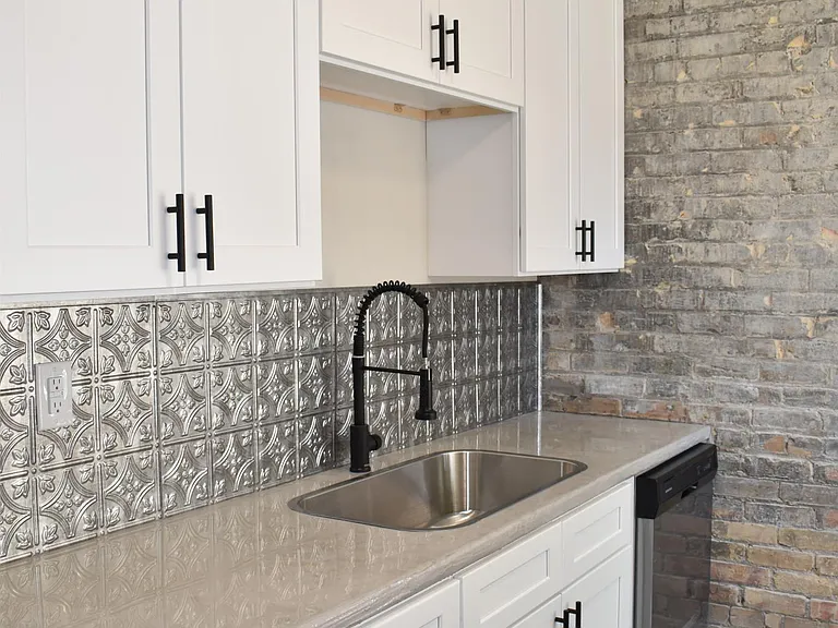 Concrete countertops are sealed. Garbage disposal and dishwasher are included amenities.