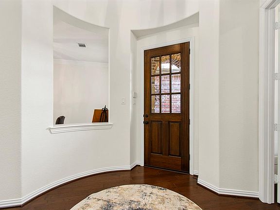 Upon entering the home in this unique round vestibule, the freshly painted walls combined with the wood flooring set a good contrast and aesthetic. To the right of the front door, in this picture, is the entrance to the front office, to the left id t