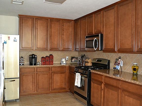 Gas stove and lots of cabinets and counter tops.