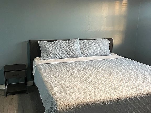 King bed with night stand. Primary bedroom measures 12 X 11