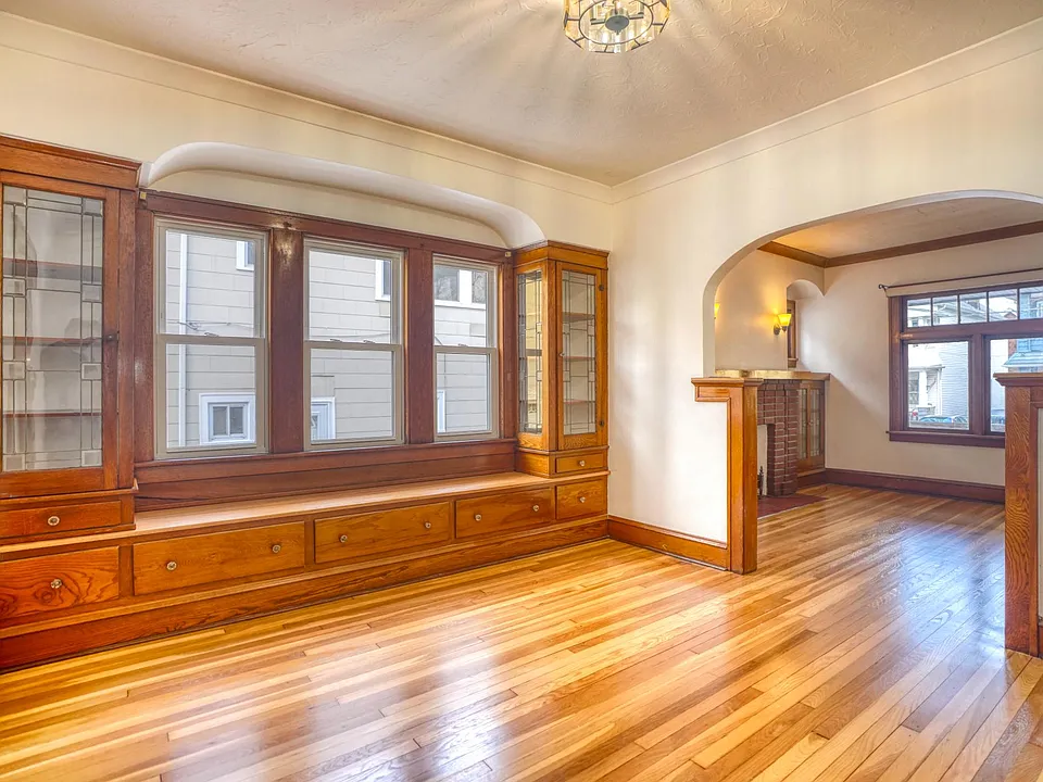 Dining Room with updated lighting, built-ins, and freshly refinished original 1926 White Oak floors