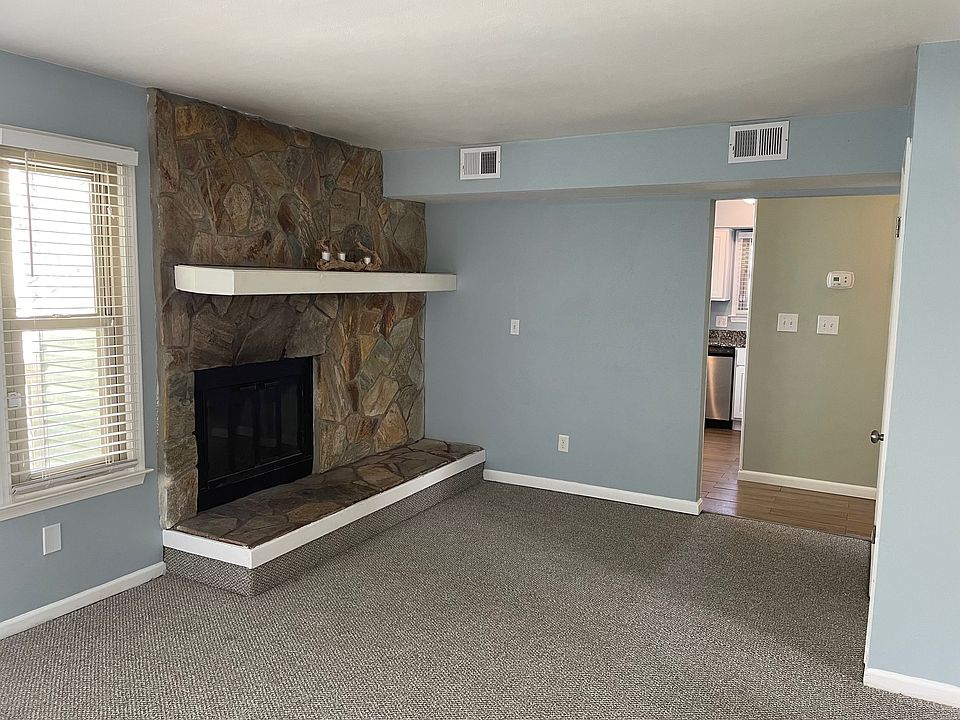 Living Room: New Carpet throughout. Fireplace & storage closet.