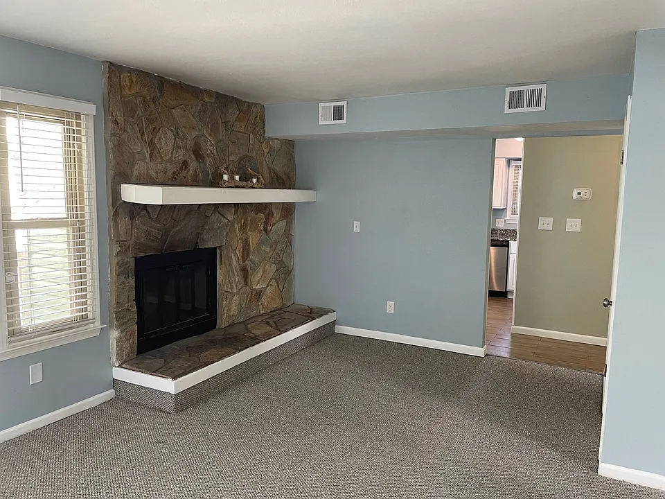 Living Room: New Carpet throughout. Fireplace & storage closet.