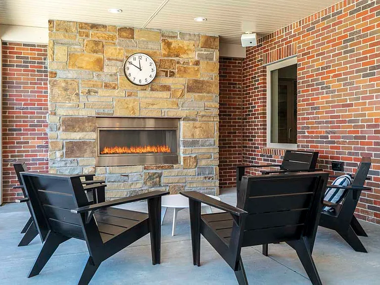 Sit by the outdoor fireplace with friends on a cool night.