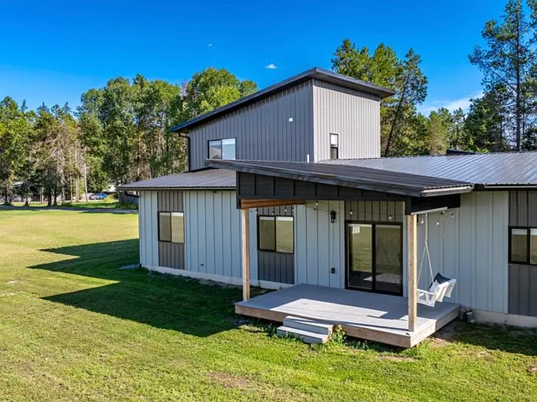 Beautiful covered porch designed for Montana living, perfect for summer BBQs, outdoor dining, and entertaining friends and family while enjoying the surrounding views and fresh mountain air.
