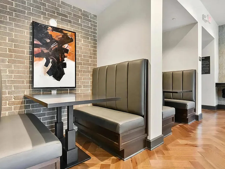 Clubhouse Lounge with Private Booth Seating and Accent Brick Wall