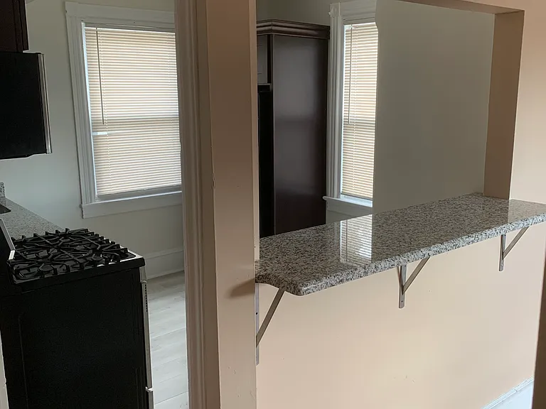 View of Kitchen, and Dining Bar from Dining Room area