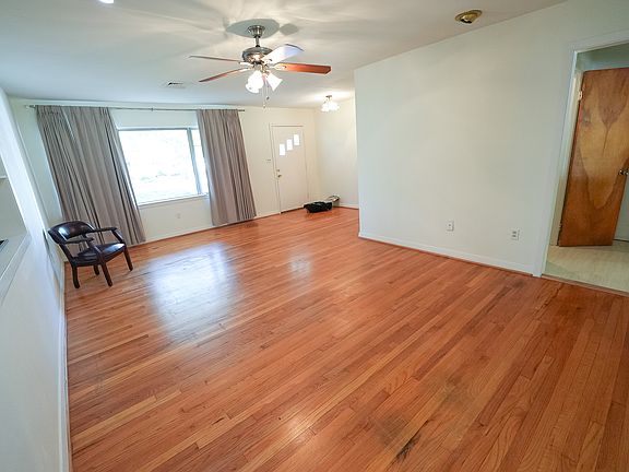 Living Room entry, bookcase with planter, exit to garage.