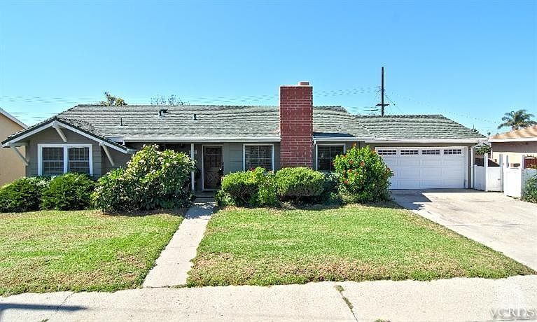 Front exterior with newer exterior paint and vinyl fencing.