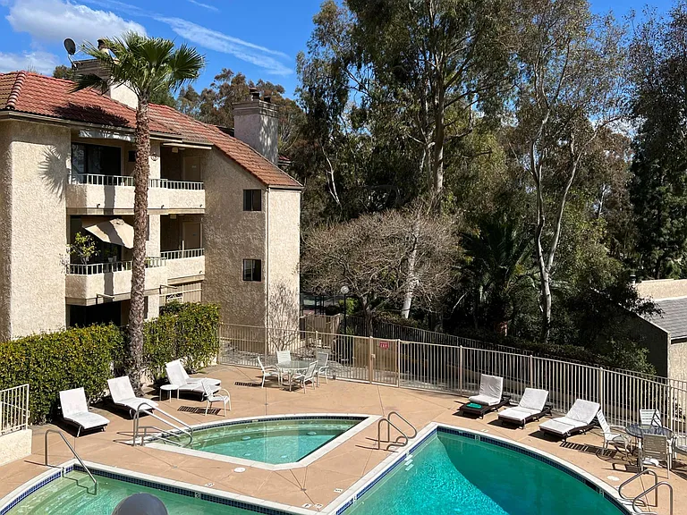 Looking down to the pool and Jacuzzi from the living room balcony