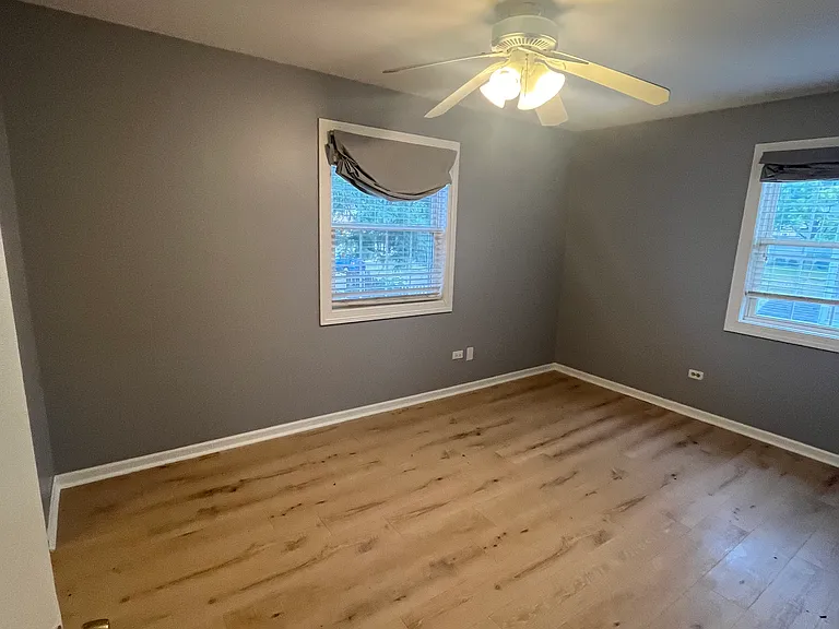 laminate flooring, premium blinds, lots of natural light in bedroom.