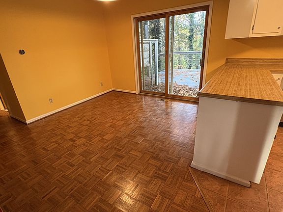 Dining area with sliding door access to a large deck.
