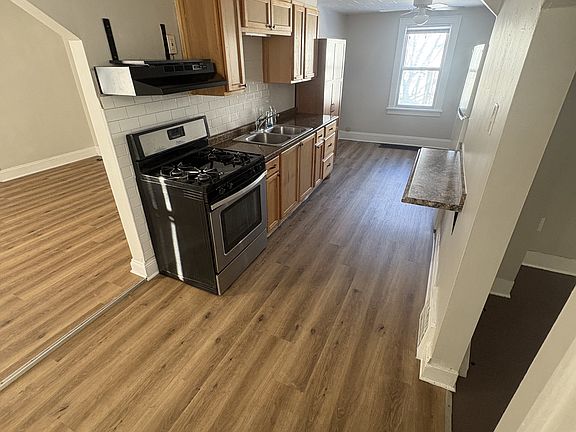kitchen with pantry. Microwave can be placed on the shelf above the stove fan.
