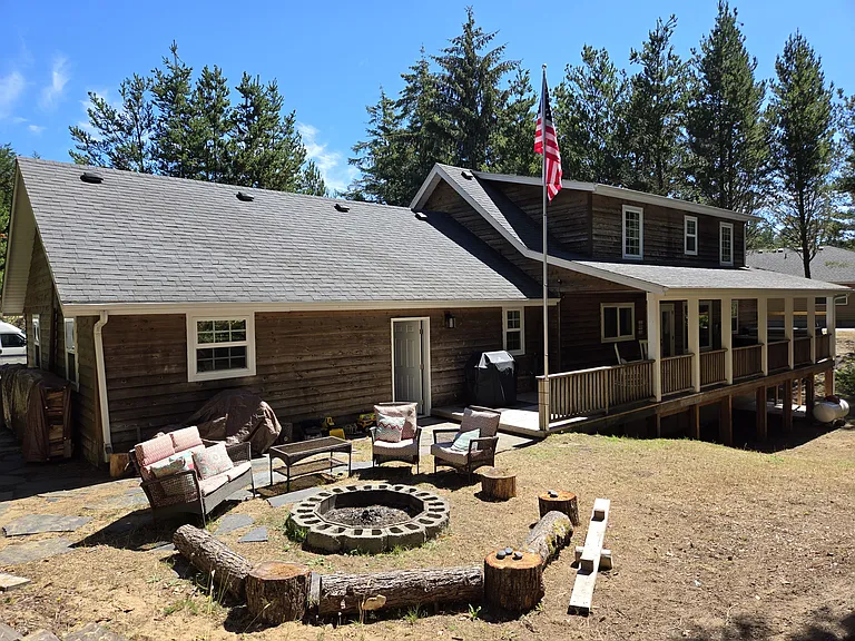 Wooded back yard with firepit