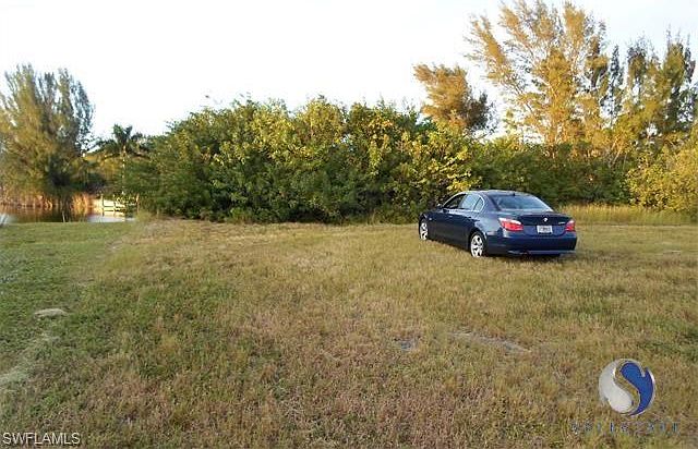 The lot is where the car is.  There is a pool home built to the left,