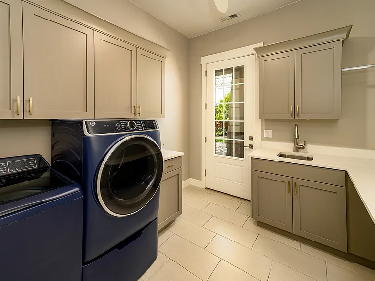 Laundry room (appliances stay) with access to backyard