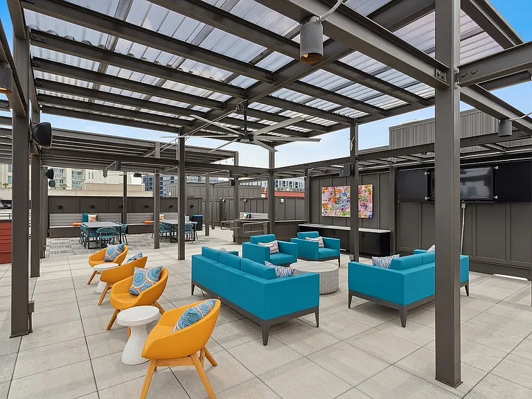 Rooftop lounge with bar, games, flat screen TVs and skyline views