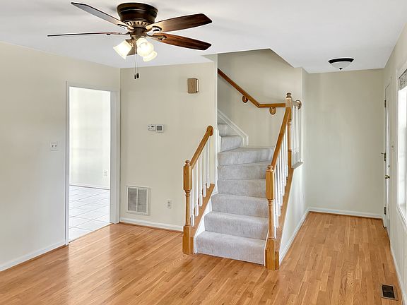 Entry way from front porch, stairs up and door to kitchen