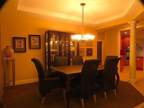 Custom designed formal dining room with updated chandelier creates the atmosphere for entertaining. Upgraded carpeting as well.