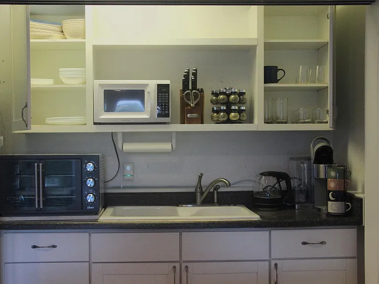 Microwave, toaster oven, coffee maker, water steamer, with all the dishes.