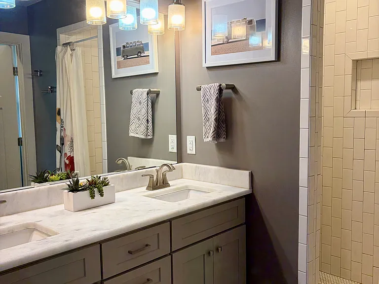 Primary bathroom with large shower and double vanities. *NOTE: house comes unfurnished (pics show current owner's furnishings that will be moved).*