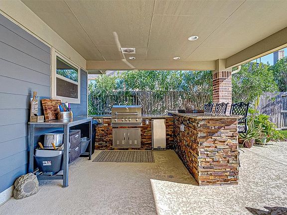 Your outdoor entertaining area! Grill, ice maker, cooktop, bar and plumbed for future sink or outdoor bath.