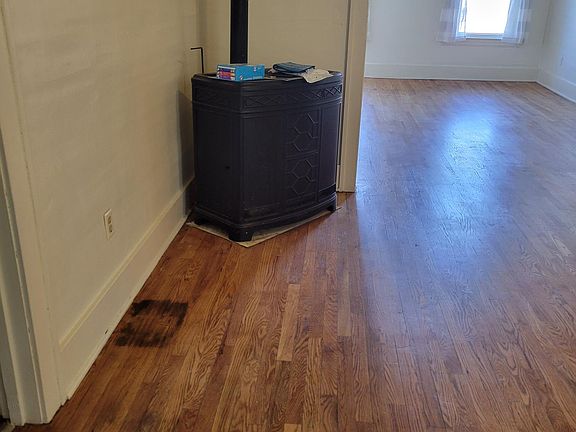 Large dining room with open floor plan into living room and continuous hardwood floors