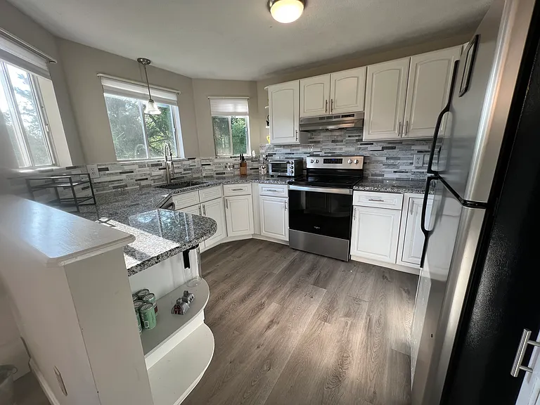 Updated kitchen with granite countertops and stainless appliances.
