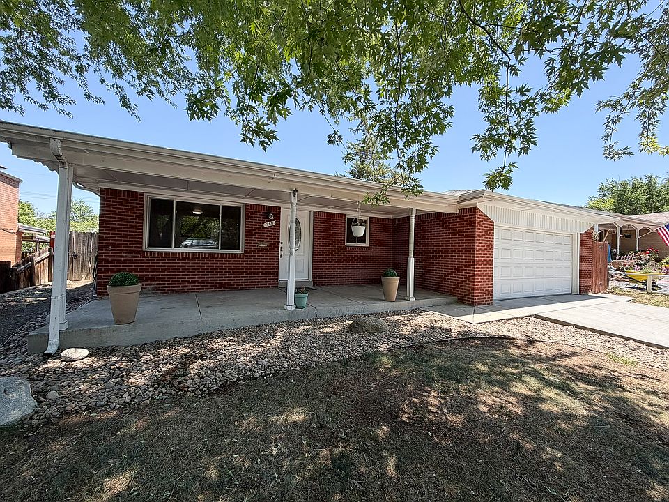 Covered front porch with huge shade tree, two car garage