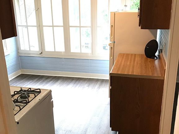 New floors throughout entire apartment. Looking into kitchen from bedroom.