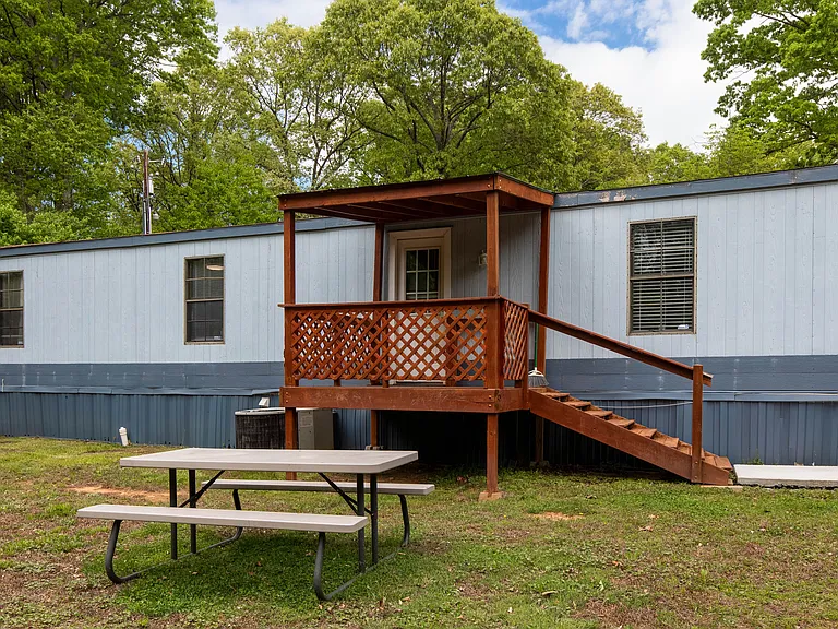 Back yard includes a picnic table & stainless steel grill