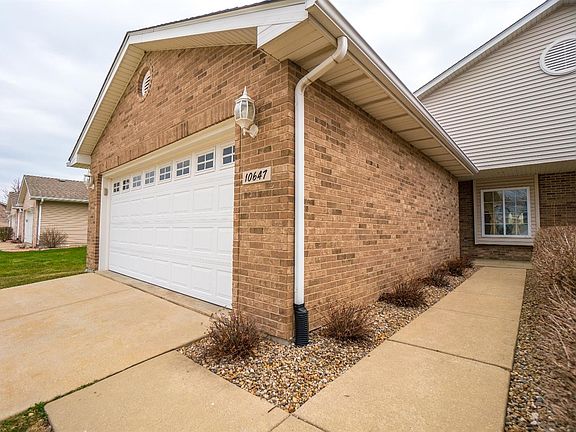 VIEW OF FRONT OF HOME W/BRICK FRONT, CONCRETE DRIVEWAY AND UPGRADED GARAGE DOOR W/WINDOWS!