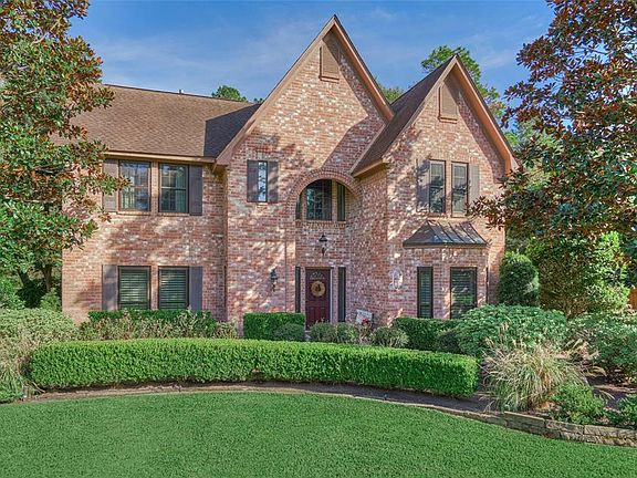 The custom built home sits on a large private corner lot with a greenbelt to the rear.