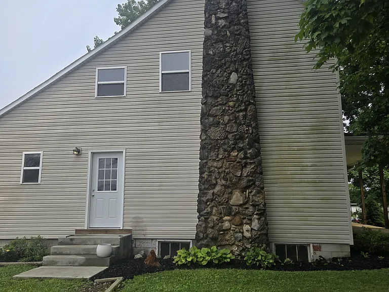 Side view of beautiful stone chimney (fireplace not in working order)