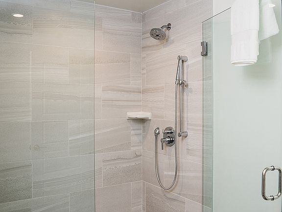 Oversized showers with floor to ceiling tile