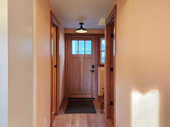 Beautiful hall with oak floors and fir trim. You enter looking south to a living room full of light.
