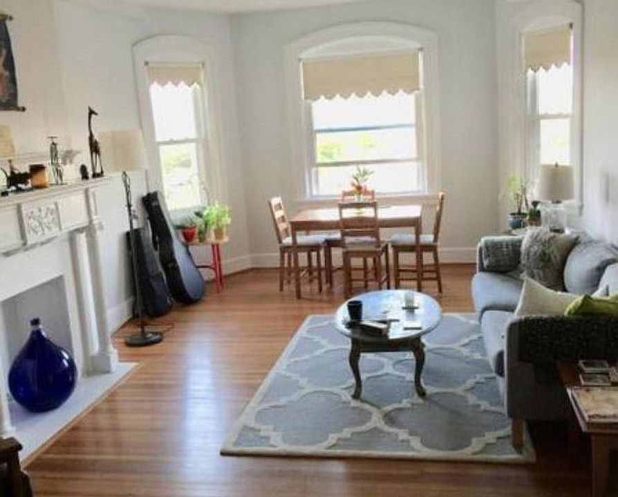 Living room with large windows overlooking Mt. Pleasant and the Washington Cathedral in the distance.