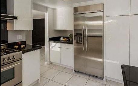 Kitchen with stainless appliances, leading to Family Room