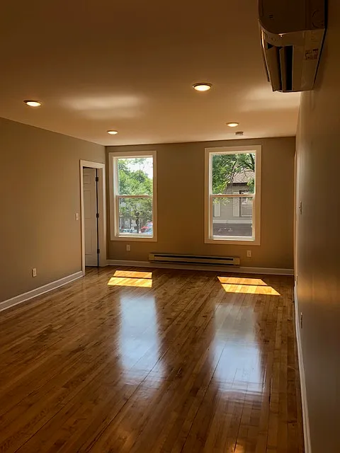 Original hardwood floors with natural sunlight